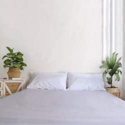 SleepFROG white fitted sheet on bed with 2 pillows 